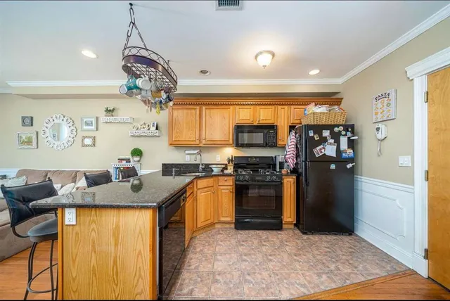 a view of a dining room with furniture and chandelier