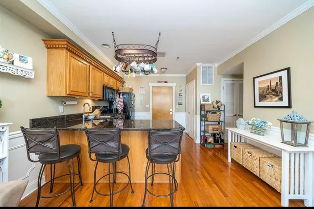a bedroom with a large bed and wooden floor