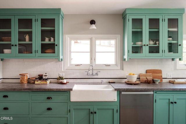 a kitchen with cabinets a sink and a window