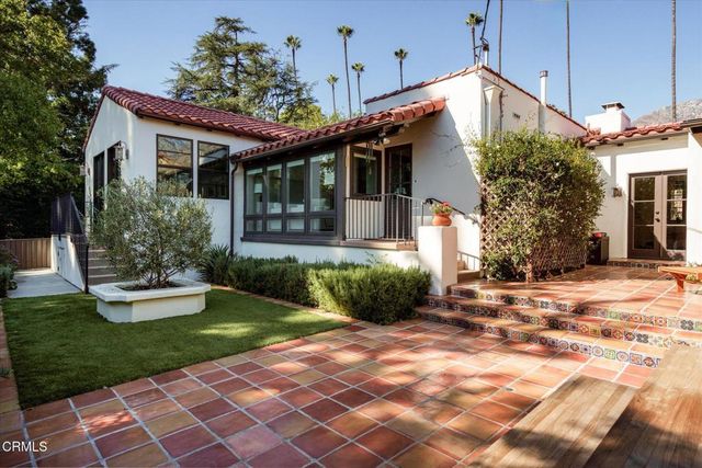 a kitchen with stainless steel appliances granite countertop a refrigerator a stove top oven a sink and dishwasher