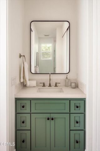 a view of a patio with couches and table under an umbrella