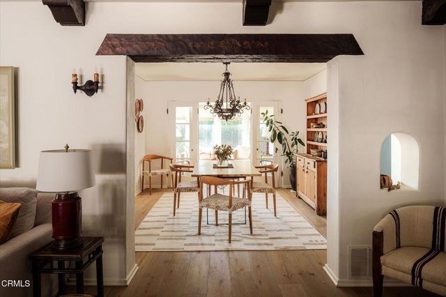 a view of a dining room with furniture and wooden floor