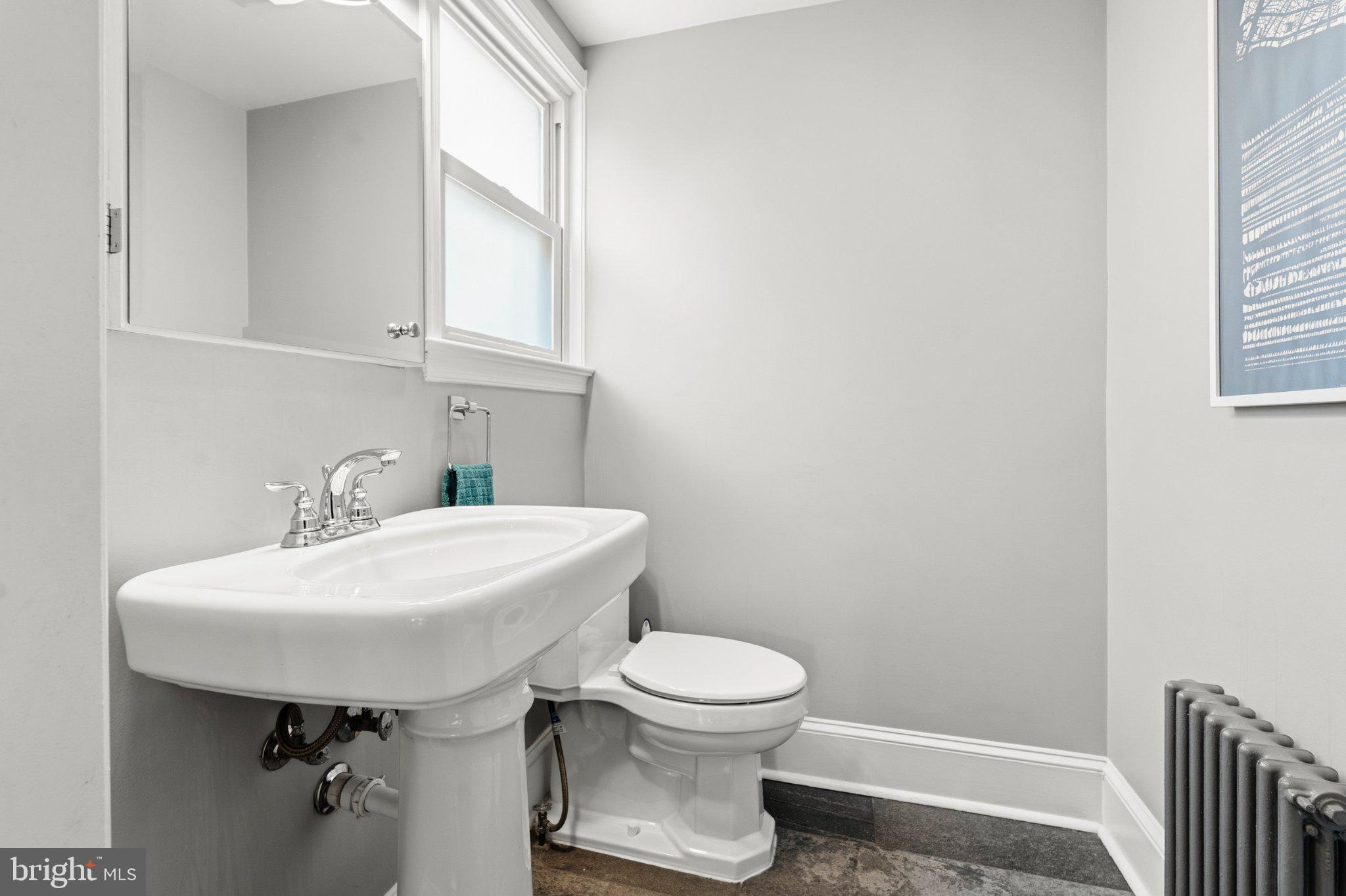 148 Todd Place Northeast Washington, DC 20002 - Photo 12 of 43 a bathroom with a sink a toilet and a mirror