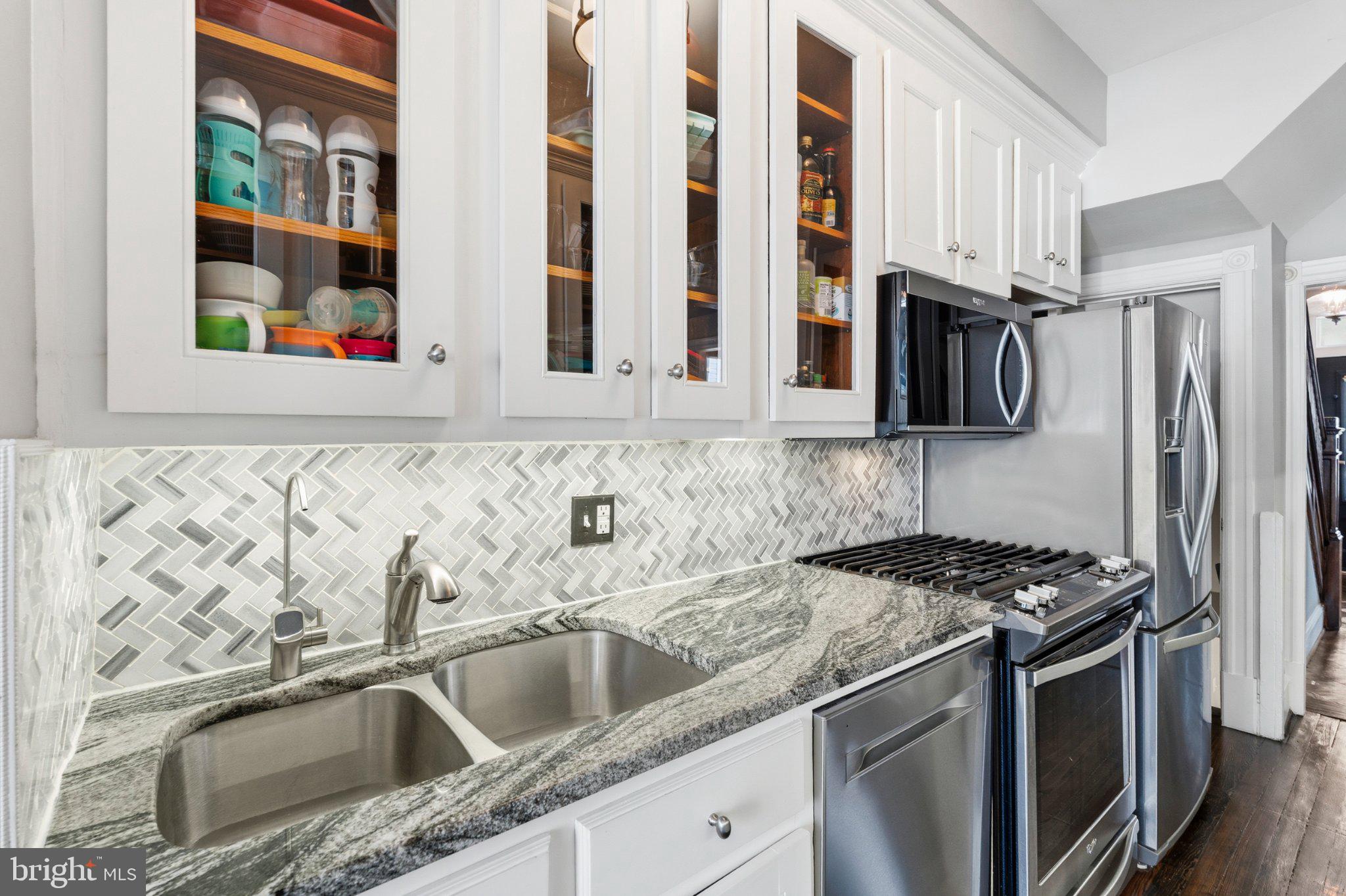 148 Todd Place Northeast Washington, DC 20002 - Photo 17 of 43 a kitchen with stainless steel appliances granite countertop a sink and a stove