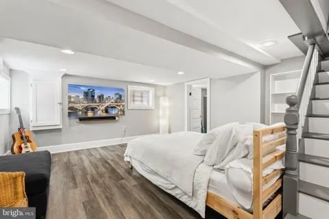 a kitchen with stainless steel appliances granite countertop a refrigerator a stove a sink and white cabinets
