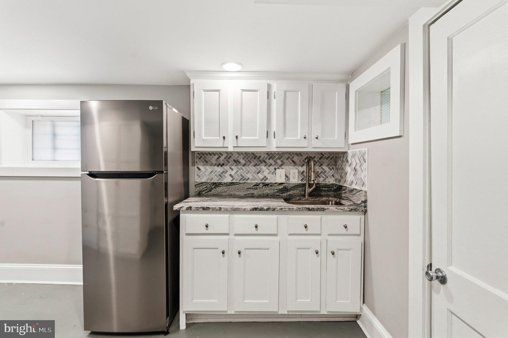 148 Todd Place Northeast Washington, DC 20002 - Photo 26 of 43 a kitchen with stainless steel appliances granite countertop a refrigerator a stove a sink and white cabinets