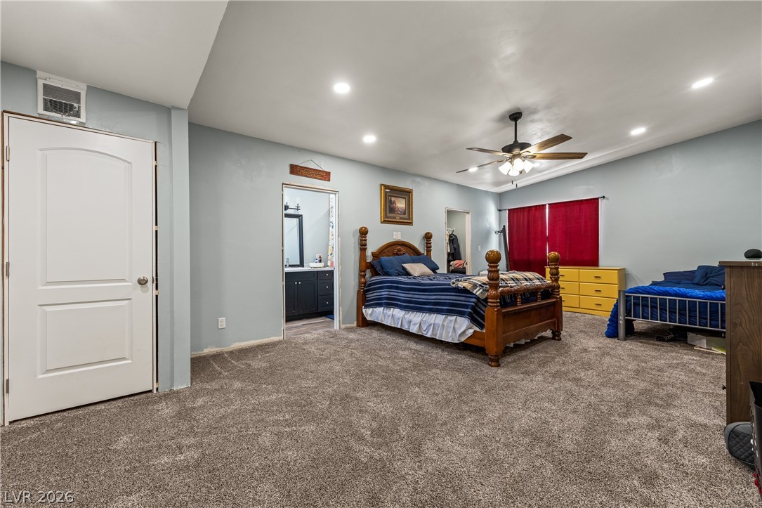750 Leming Avenue Overton, NV 89040 - Photo 47 of 82 This spacious bedroom offers comfortable carpeting and convenient access to an adjacent bathroom.