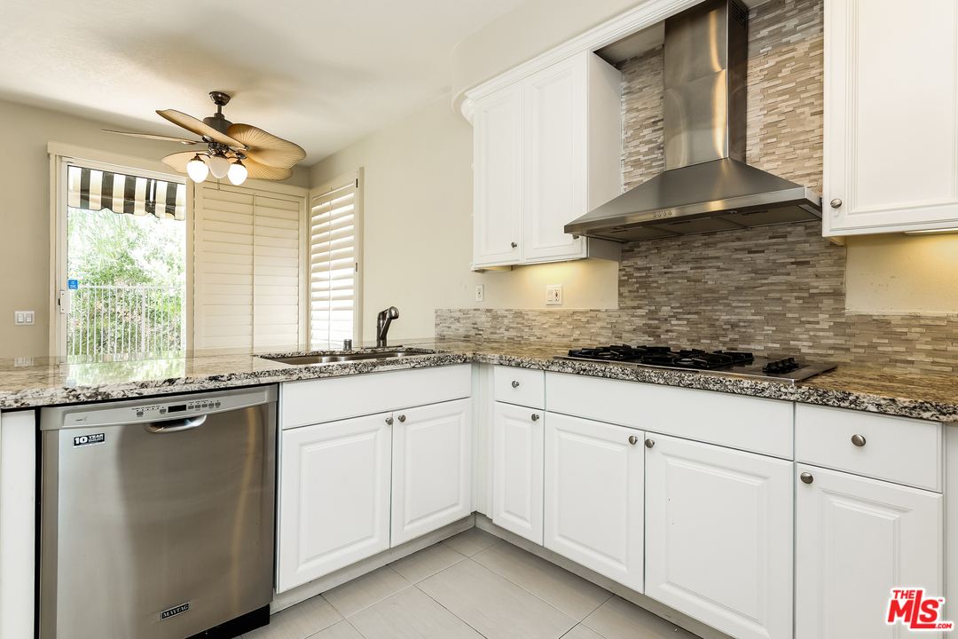 6 Alamitos Foothill Ranch, CA 92610 - Photo 12 of 27 a kitchen with granite countertop white cabinets and white appliances