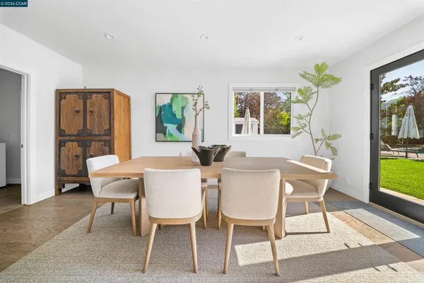 a view of a dining room with furniture window and wooden floor