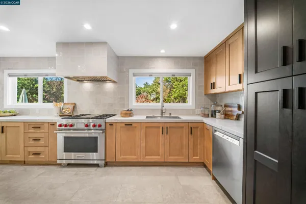 a kitchen with a stove oven and sink
