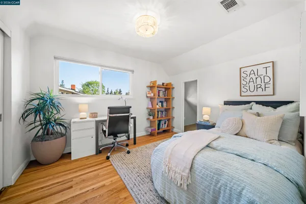 a bedroom with a bed and a potted plant