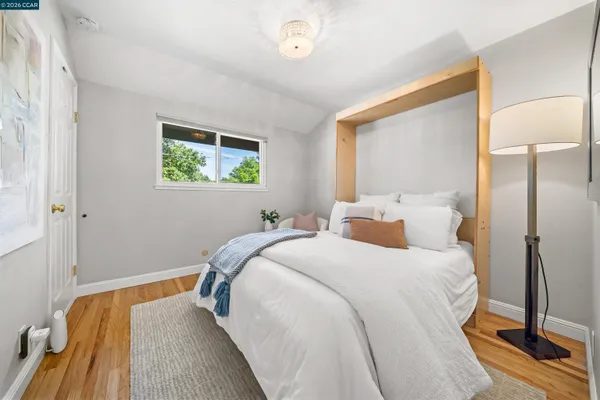 a bedroom with a bed and a painting on the wall
