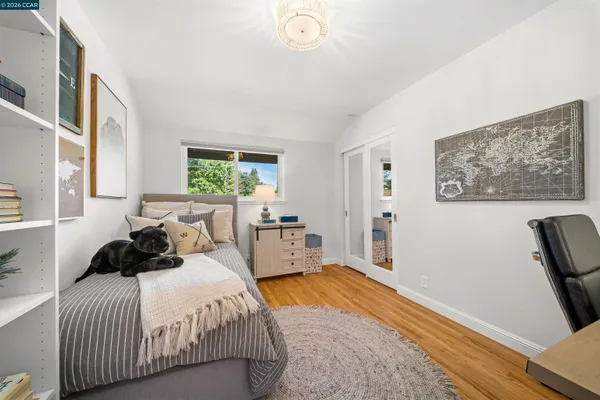 a bedroom with a large bed and a window