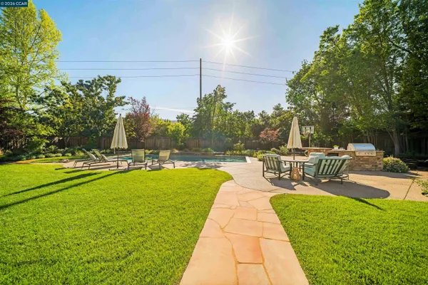 a swimming pool with outdoor seating and yard