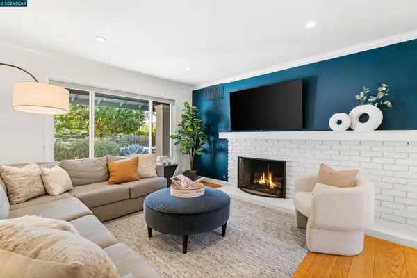 a living room with furniture and a fireplace