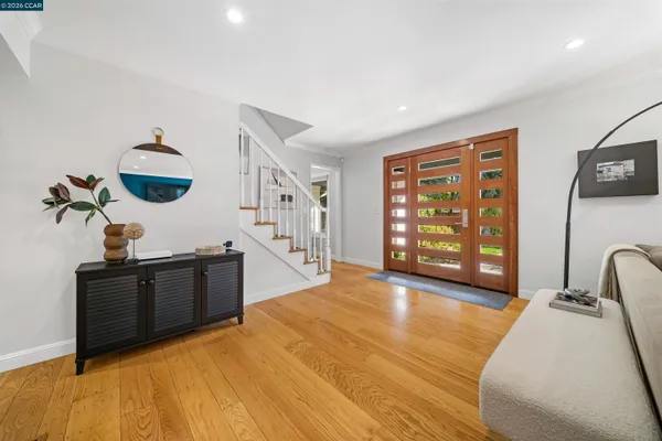 a view of a livingroom with furniture and staircase