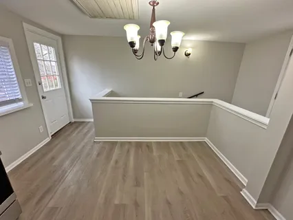 a view of room with window and wooden floor