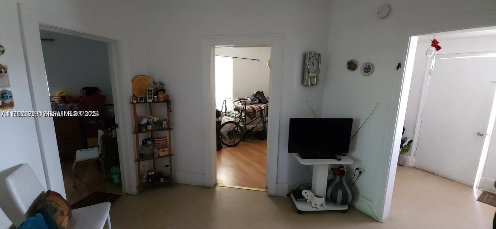 251 Northwest 34th Terrace Miami, FL 33127 - Photo 5 of 12 a living room with furniture and a flat screen tv