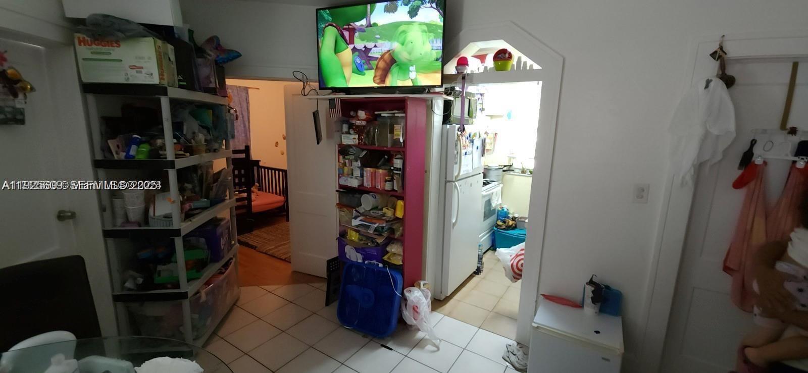 251 Northwest 34th Terrace Miami, FL 33127 - Photo 9 of 12 a room with lots of different colored cloths