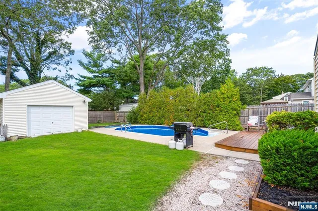 a view of a backyard with sitting area