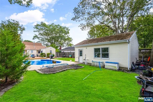 a view of a house with backyard and sitting area
