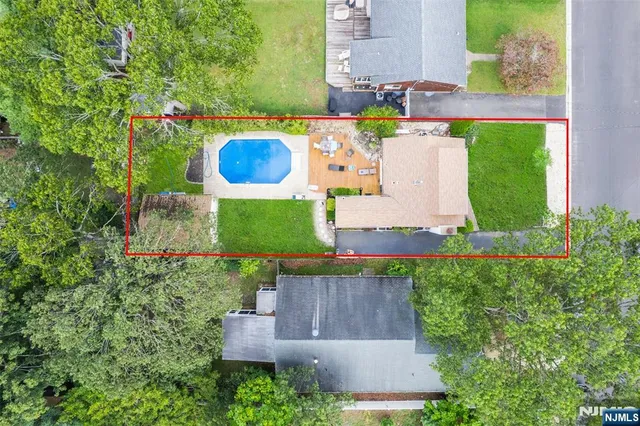 an aerial view of a house with a yard and lake view