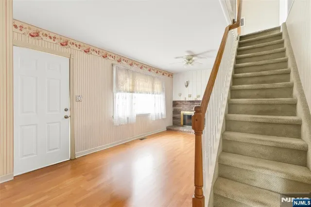 a view of entryway with wooden floor and stairs