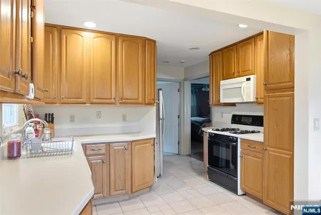 a kitchen with a stove a sink and a refrigerator