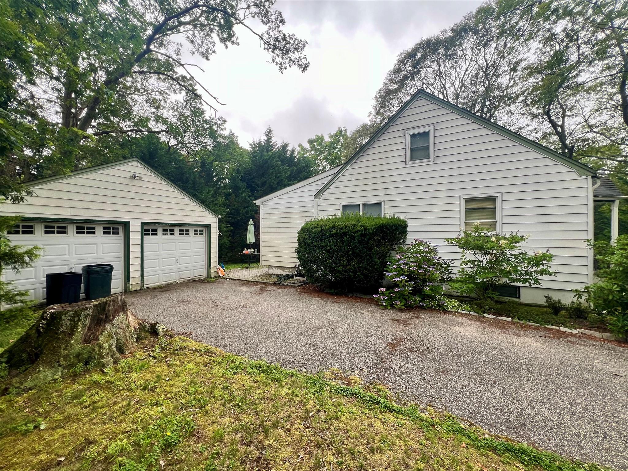 100 Maple Lane Medford, NY 11763 - Photo 3 of 13 View of property exterior featuring an outdoor structure and a garage