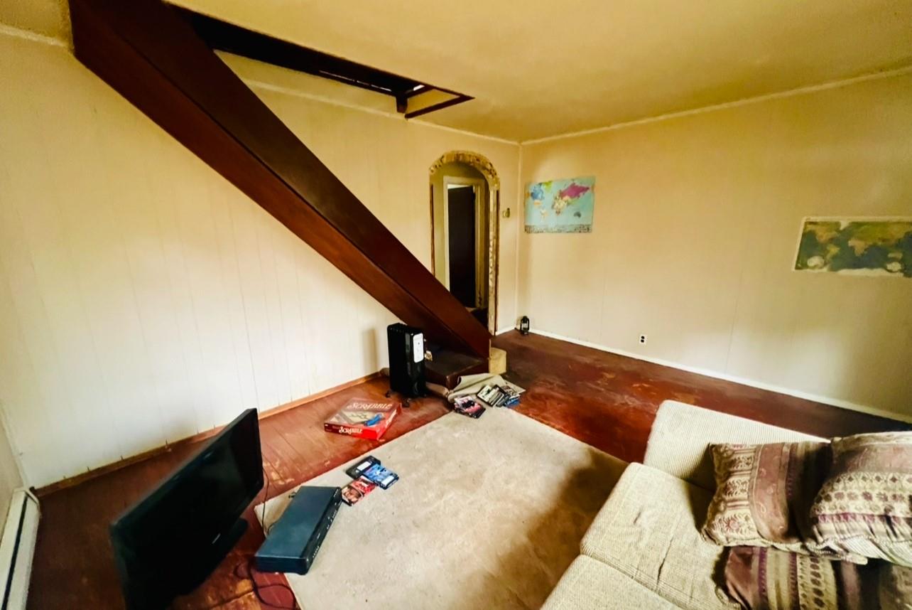 100 Maple Lane Medford, NY 11763 - Photo 4 of 13 Living room with a baseboard radiator and wood finished floors