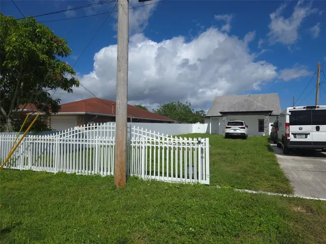 a view of a house with a yard and deck