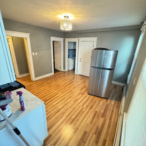a view of kitchen with sink and refrigerator