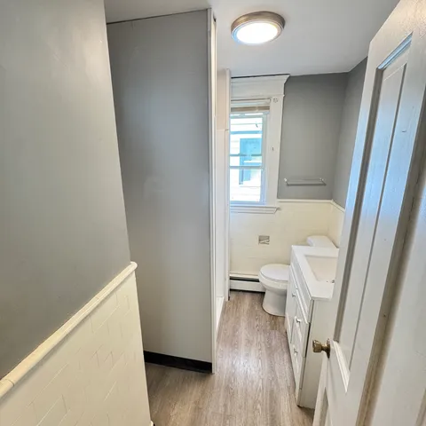 a bathroom with a tub shower and sink