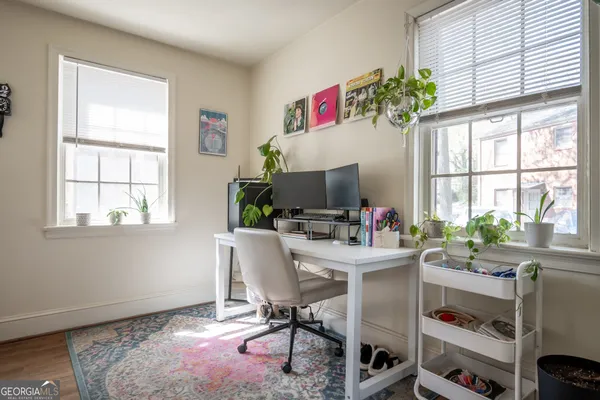 a view of a workspace with furniture and a window
