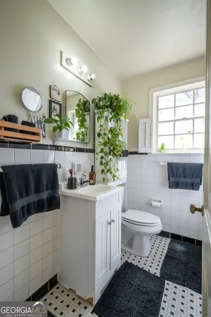 a bathroom with a sink a toilet and window