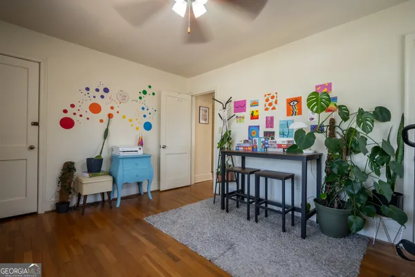 a bedroom with furniture and a potted plant