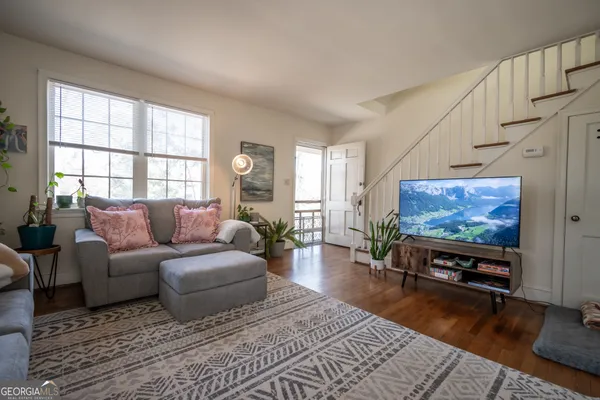 a living room with furniture and a flat screen tv
