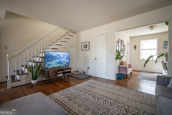 a bedroom with furniture and a wooden floor
