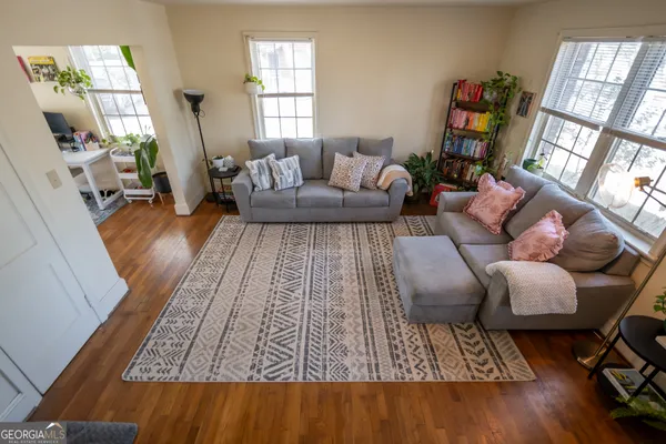 a living room with furniture and a rug