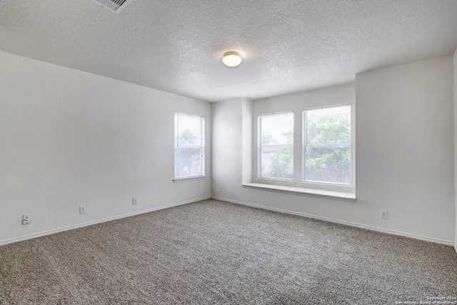 an empty room with windows and closet