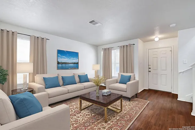 a living room with furniture and wooden floor