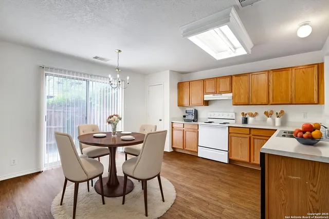 a kitchen that has a table and chairs in it