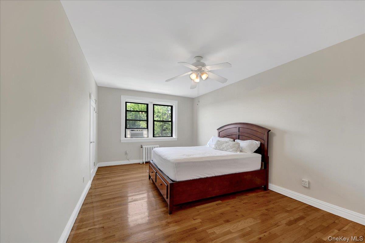 4784 Boston Post Road, Unit B43 Pelham, NY 10803 - Photo 11 of 22 a bed sitting in a spacious bedroom next to a window