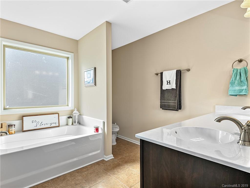 125 North River Road Fletcher, NC 28732 - Photo 11 of 18 a bathroom with a tub sink and mirror