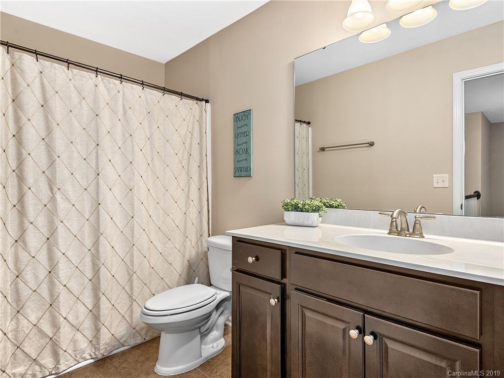 125 North River Road Fletcher, NC 28732 - Photo 15 of 18 a bathroom with a granite countertop sink and a mirror