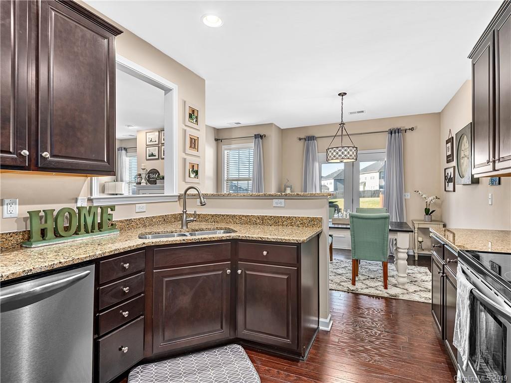 125 North River Road Fletcher, NC 28732 - Photo 6 of 18 a kitchen with granite countertop a sink a counter space appliances and cabinets