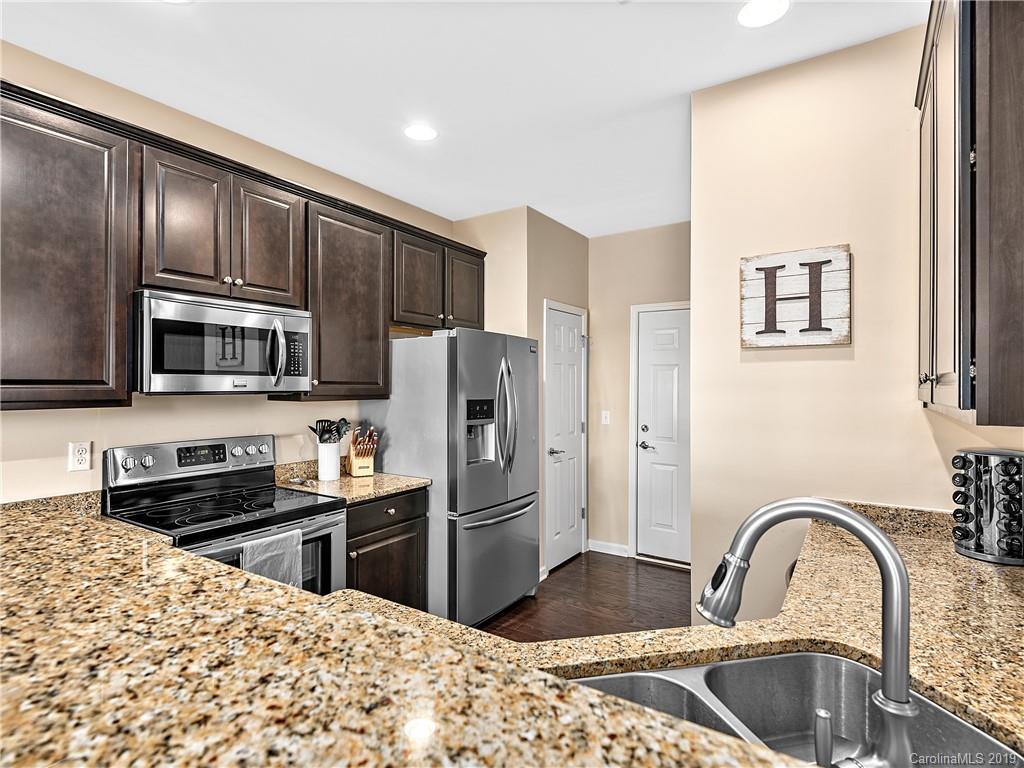 125 North River Road Fletcher, NC 28732 - Photo 7 of 18 a kitchen with stainless steel appliances granite countertop a refrigerator and a stove top oven