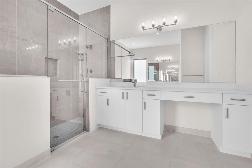 10990 Violet Mdw Street Boynton Beach, FL 33473 - Photo 15 of 60 a bathroom with a shower sink and mirror