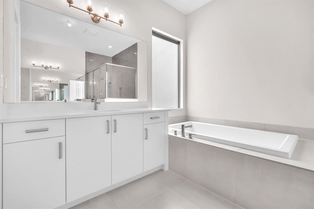 10990 Violet Mdw Street Boynton Beach, FL 33473 - Photo 16 of 60 a bathroom with a bathtub and a sink