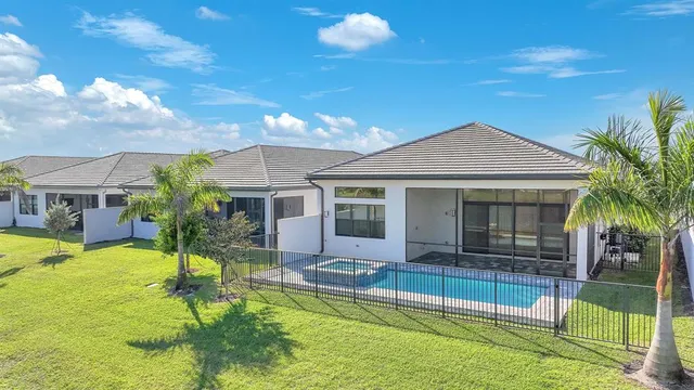 a view of a house with a backyard and a garden